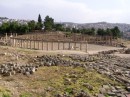Oval Plaza from above * The spacious plaza measures 90 x 80 m and is surrounded by a broad sidewalk and a colonnade of 1st century Ionic columns. There are 2 altars in the middle, and a fountain was added in the 7th century AD. This square structure now supports a central column, which was recently erected to carry the Jerash Festival flame. * 432 x 323 * (74KB)